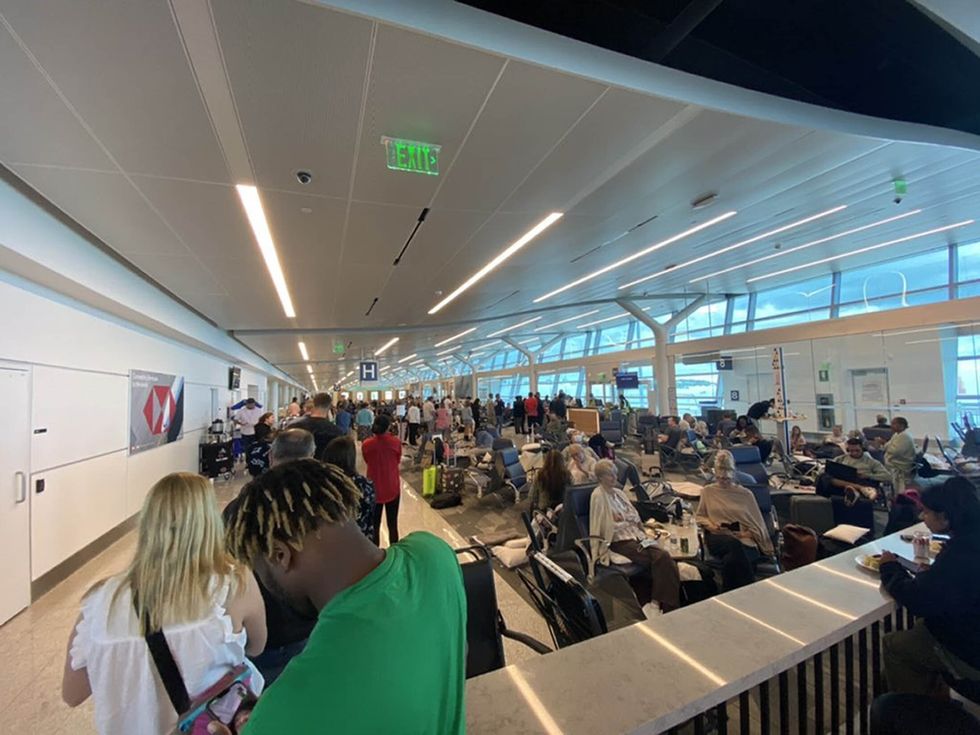 Undated handout photo issued by Jonathan Lo of passengers at L.F. Wade International Airport in St.George's, Bermuda, after their American Airlines flight from Miami to London had to divert due to a possible mechanical issue. Issue date: Monday August 29, 2022.
