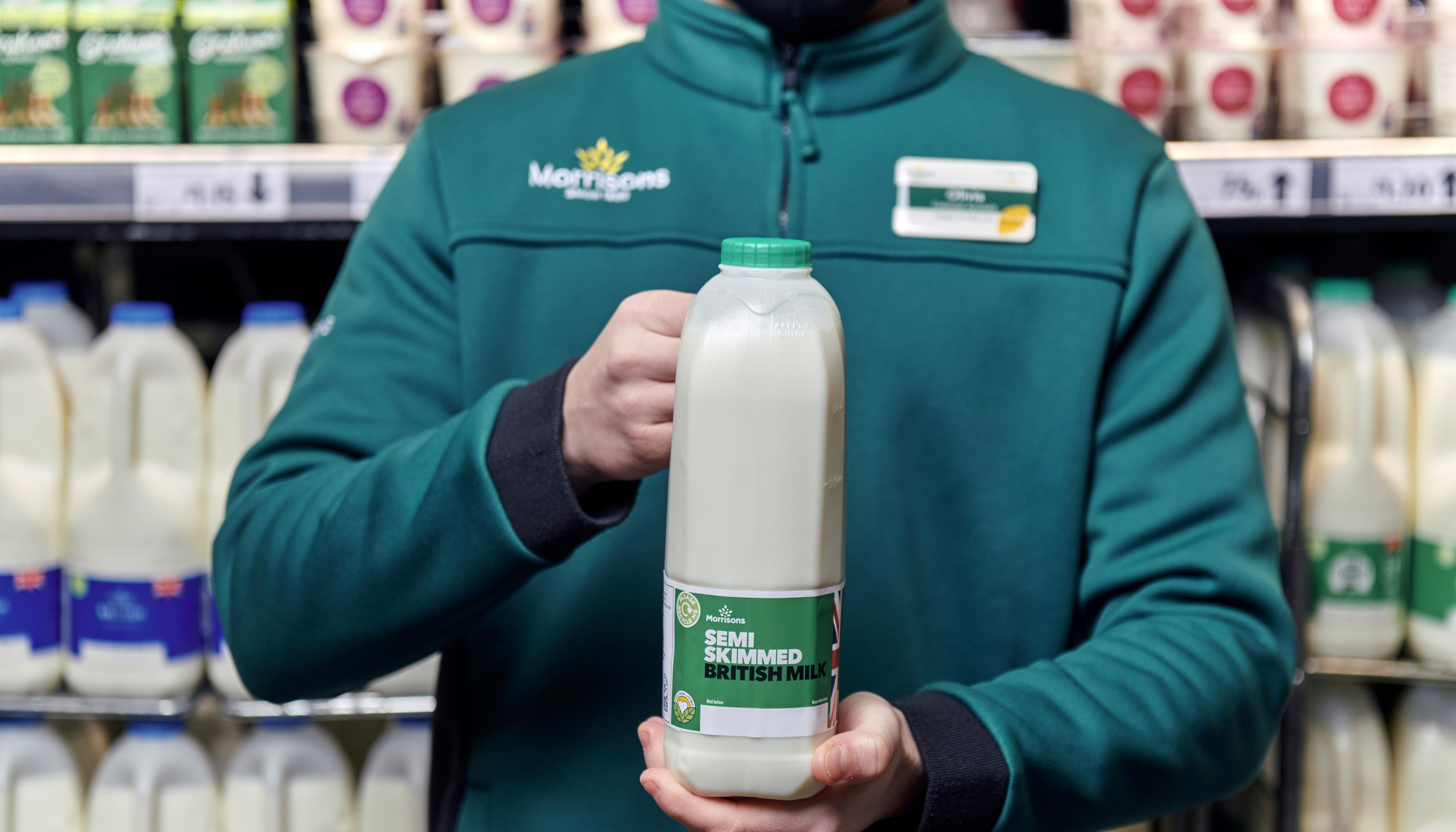 Undated handout photo issued by Morrisons of a staff member holding up a bottle of its own brand milk, Supermarket Morrisons is to scrap %22use by%22 dates on most of its milk in a bid to reduce food waste. From the end of January, the retailer will instead place %22best before%22 dates on 90% of its own-brand milk and will encourage customers to use a sniff test to check quality. Issue date: Sunday January 9, 2022.