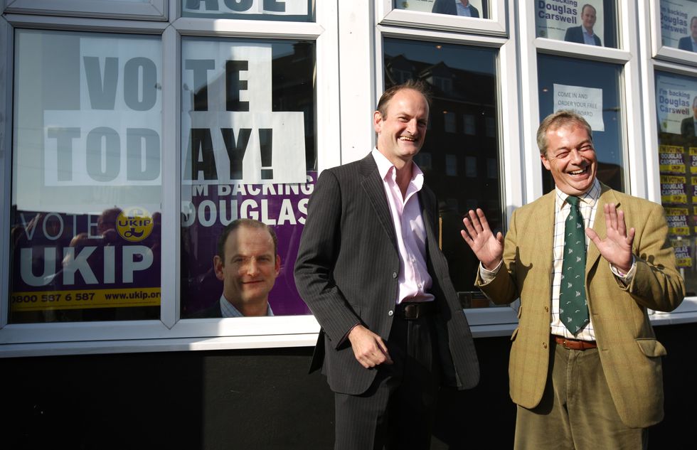 United Kingdom Independence Party (UKIP) candidate Douglas Carswell (L) stands with party leader Nigel Farage on October 9, 2014