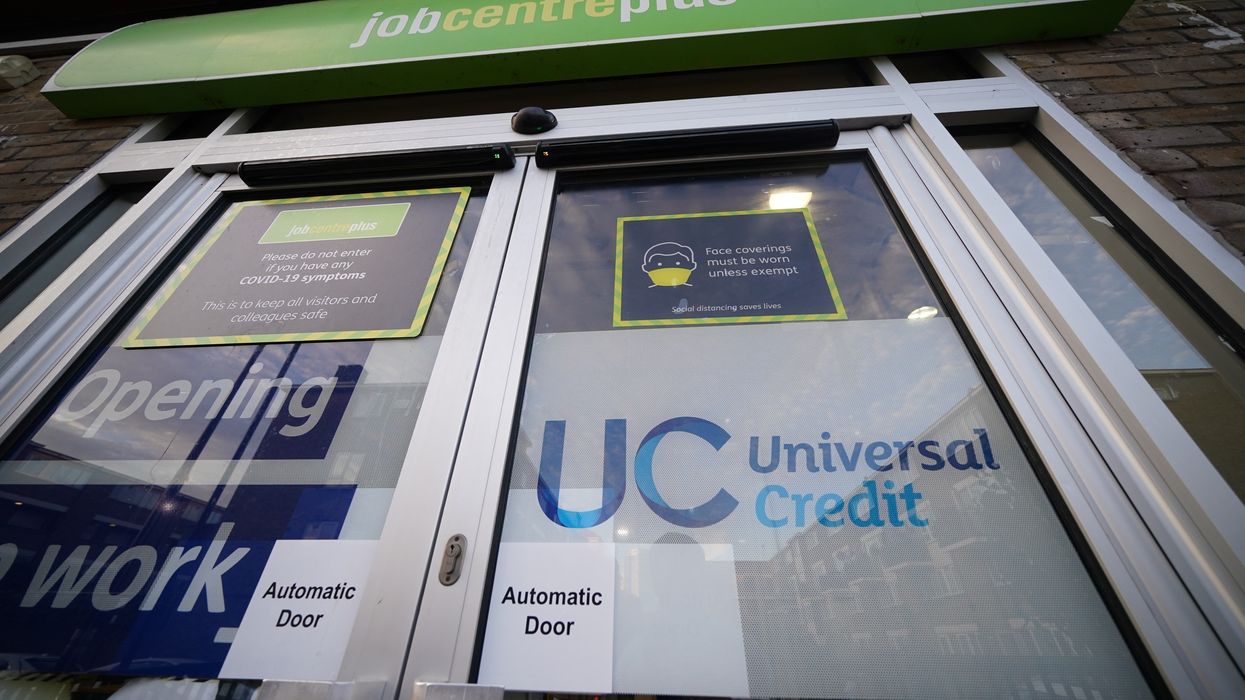 Universal Credit sign on the door of a job centre plus in east London