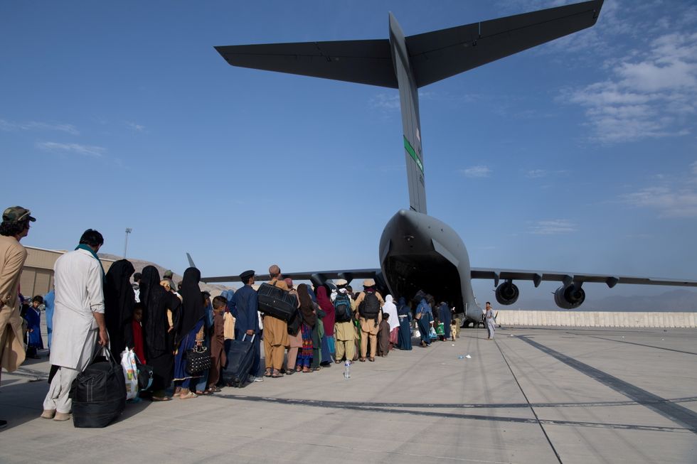 US Air Force loadmasters and pilots assigned to the 816th Expeditionary Airlift Squadron, load passengers aboard a U.S. Air Force C-17 Globemaster III in support of the Afghanistan evacuation at Hamid Karzai International Airport in Kabul, Afghanistan.