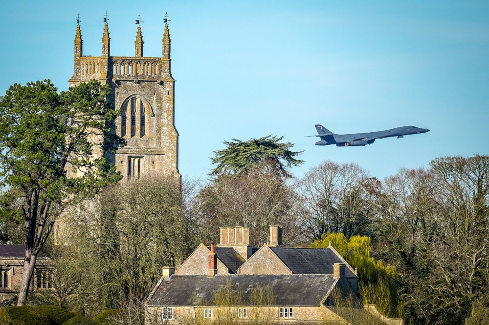 US Bomber flies above a church from RAF Fairford
