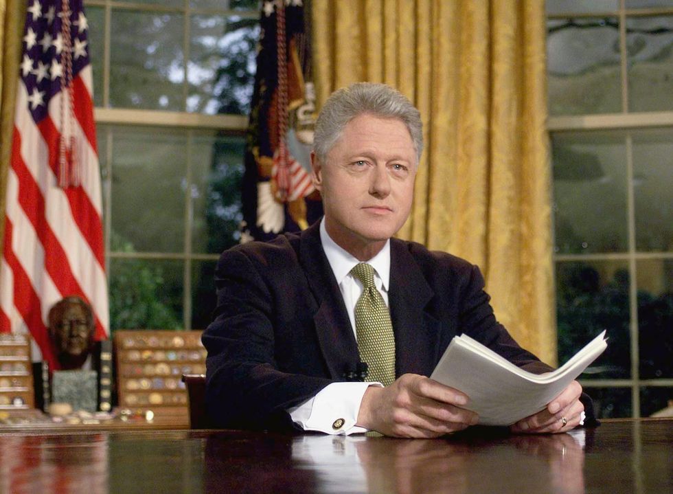 US President Bill Clinton poses for photographs after addressing the nation from the Oval Office in the White House 10 June, 1999,