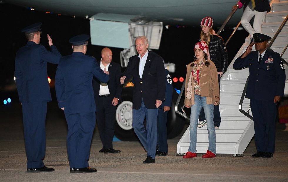 US President Joe Biden, followed by granddaughter Natalie and her friend, steps off Air Force One upon arrival at Joint Base Andrews in Maryland on January 2, 2024