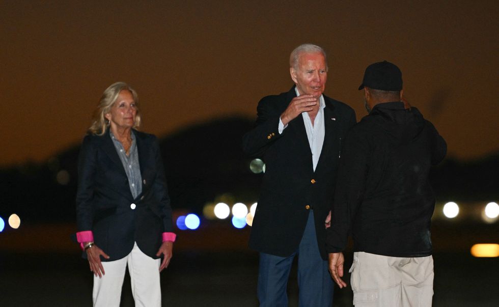 US President Joe Biden, followed by granddaughter Natalie and her friend, steps off Air Force One upon arrival at Joint Base Andrews in Maryland on January 2, 2024