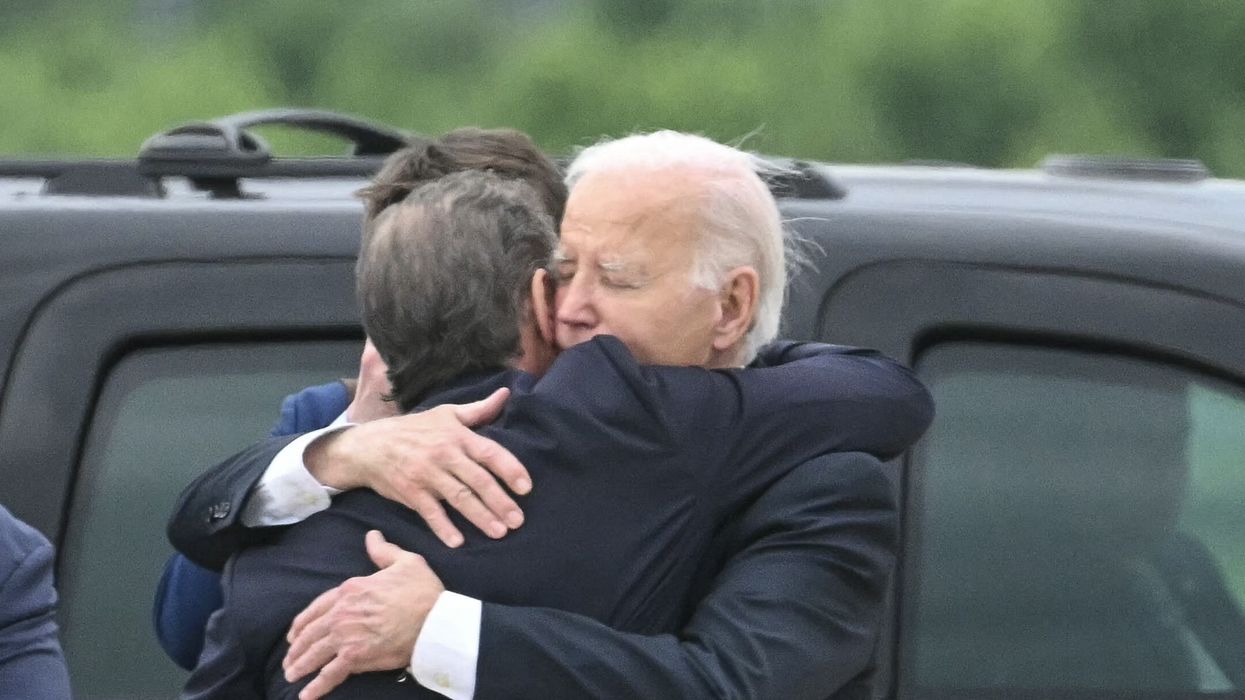 US President Joe Biden hugs his son Hunter Biden upon arrival at Delaware Air National Guard Base