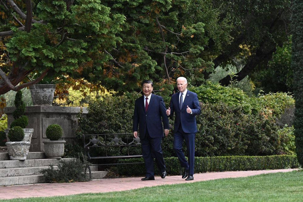 US President Joe Biden (R) and Chinese President Xi Jinping walk together after a meeting during the Asia-Pacific Economic Cooperation (APEC) Leaders' week in Woodside