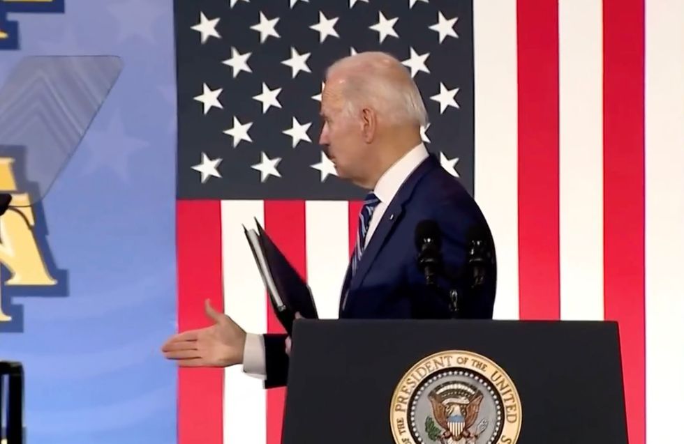US President Joe Biden shakes hands with the air