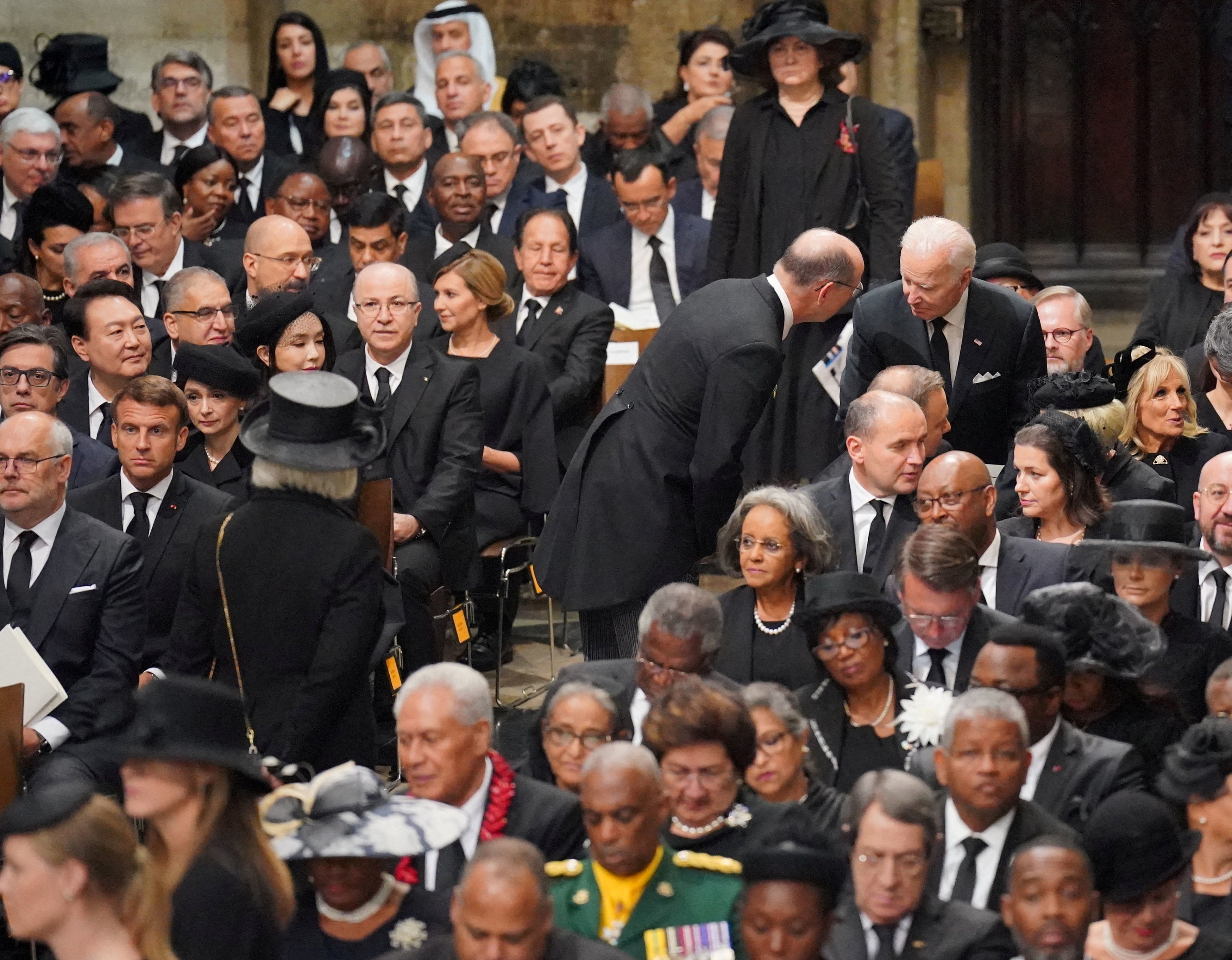 US President Joe Biden takes his seat with wife Jill Biden, other heads of state and dignitaries, including French President Emmanuel Macron at the State Funeral of Queen Elizabeth II, held at Westminster Abbey, London. Picture date: Monday September 19, 2022. Dominic Lipinski/Pool via REUTERS
