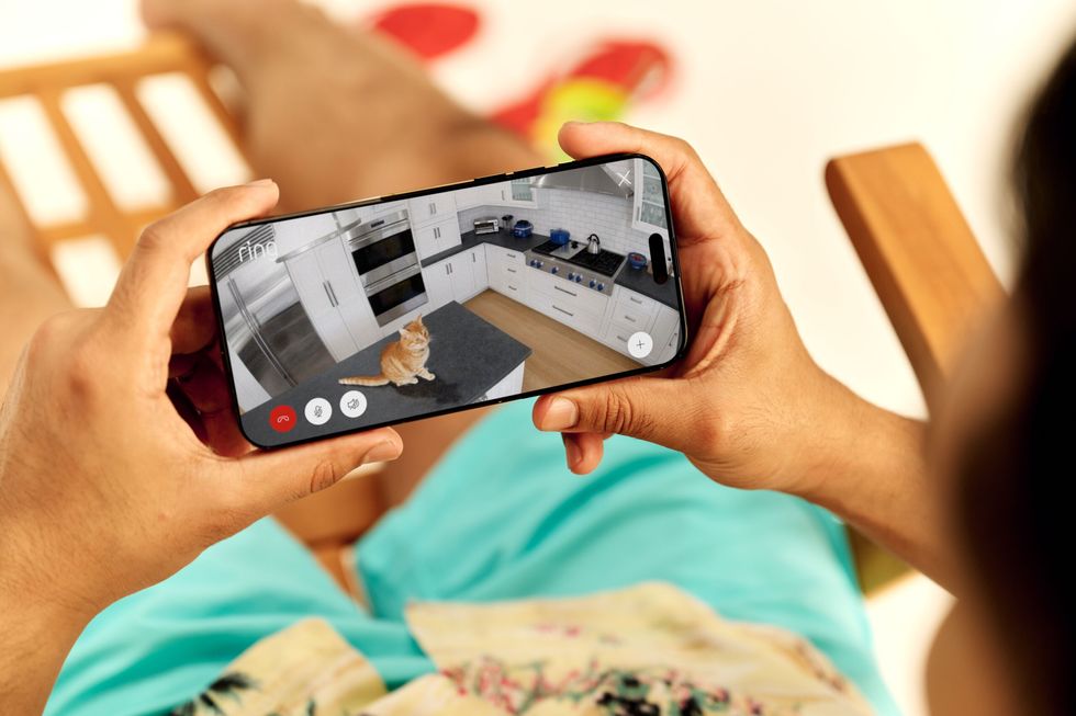 User logs into Ring app to view live security camera footage from their phone while away