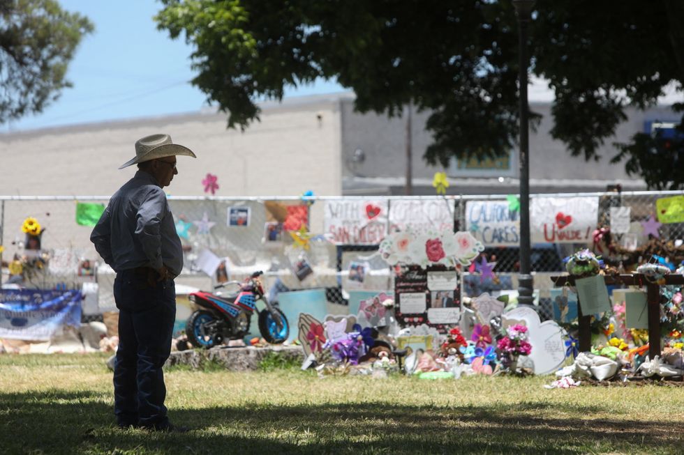 Uvalde resident Raul Nolasco Jr. stands by the memorial for victims of the Robb Elementary School shooting, at Uvalde Town Square, Texas.