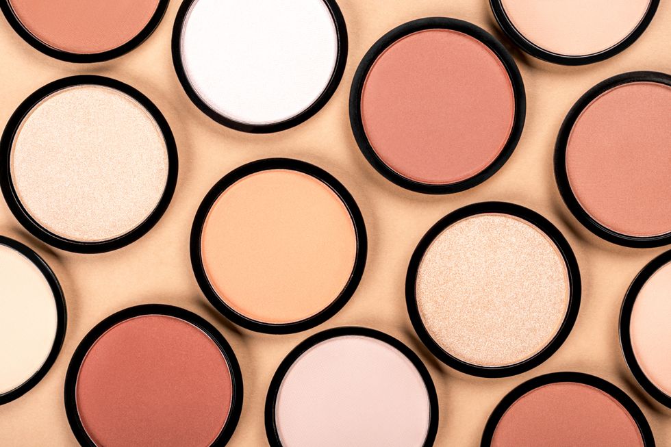 Various shades of blush lined up evenly next to each other on a peach background