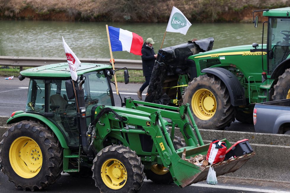 Vehicles are parked during a blockade by farmers on the A4 highway