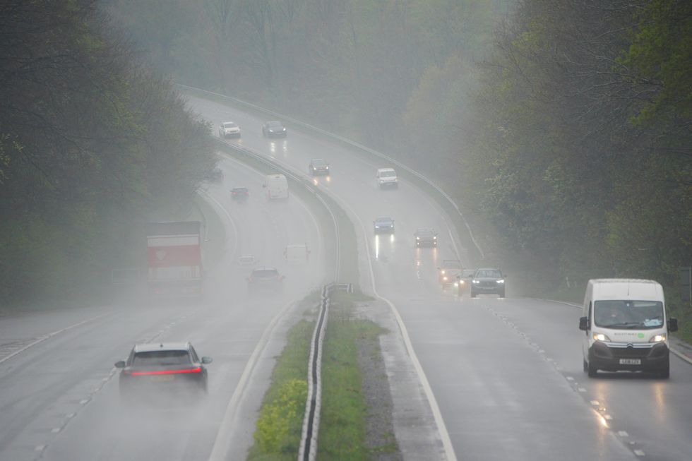Vehicles drive through rain on the A38 in Plymouth, Devon\u200b