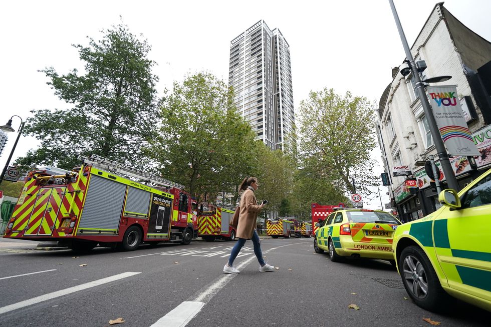 Vehicles used by the emergency services at the scene of a fire at a tower block on Deacon Street in Elephant and Castle, south London. Picture date: Thursday November 4, 2021.