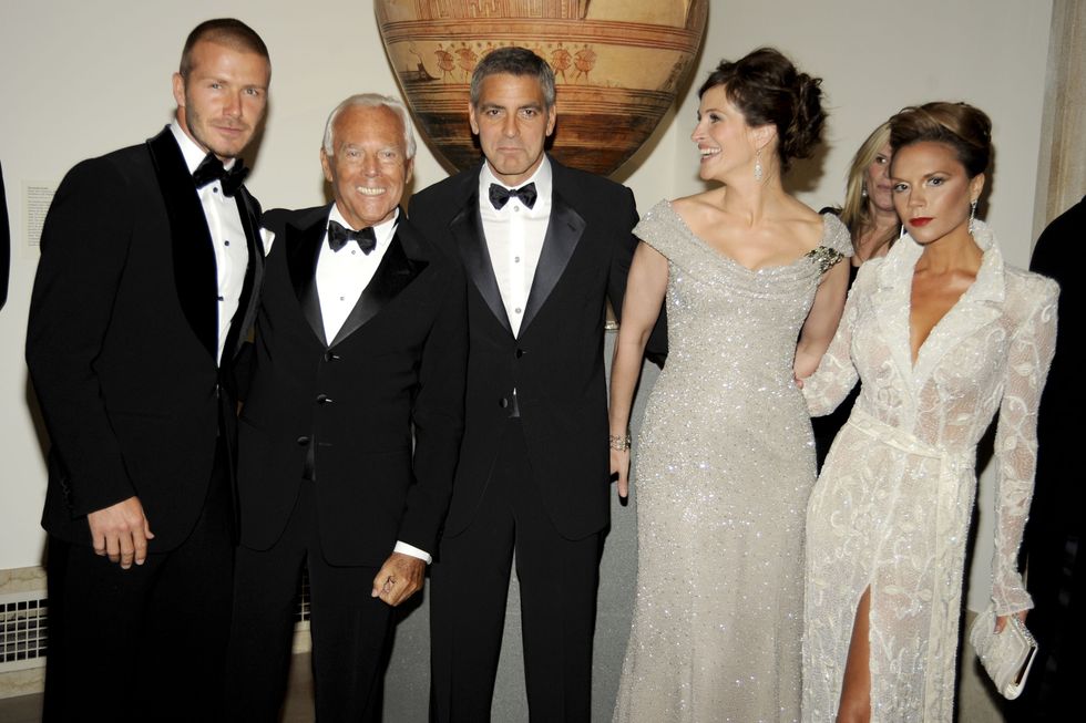 Victoria Beckham (right) has paid tribute to Giorgio Armani (second from left)