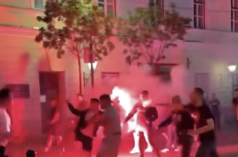 Video footage showed groups of fans lighting flares and throwing them