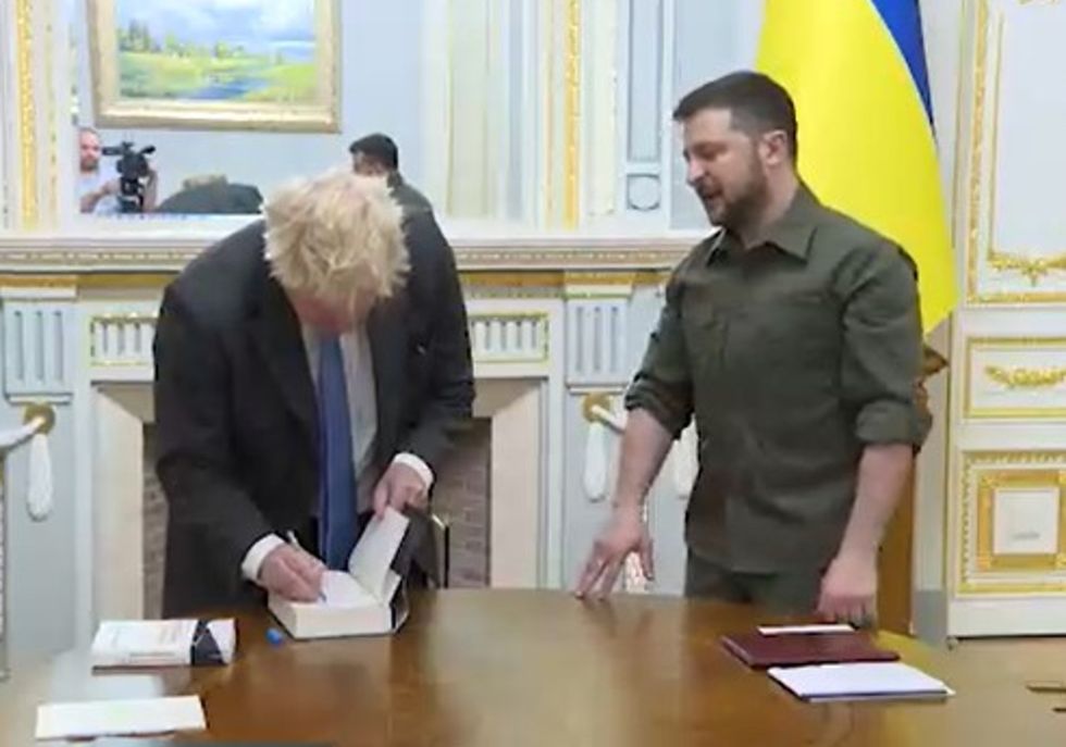 Video grab image issued by the Ukrainian Presidential Press Office of Ukrainian President Volodymyr Zelensky (right) meeting Prime Minister Boris Johnson