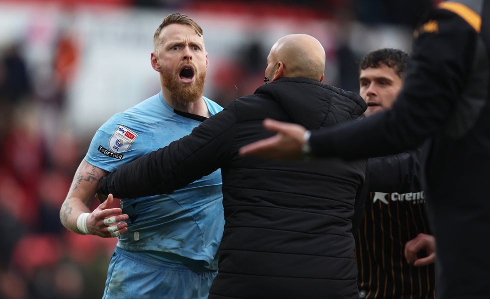 Viktor Johansson of Stoke City clashes with Hull City players