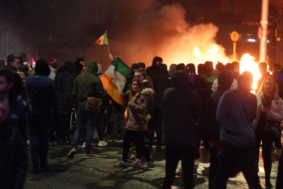 Violent scenes have unfolded close to the site of the attack in Dublin city centre as crowds of protesters gathered