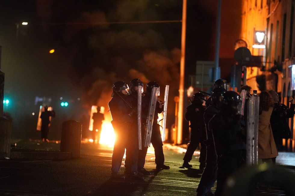 Violent scenes have unfolded close to the site of the attack in Dublin city centre as crowds of protesters gathered