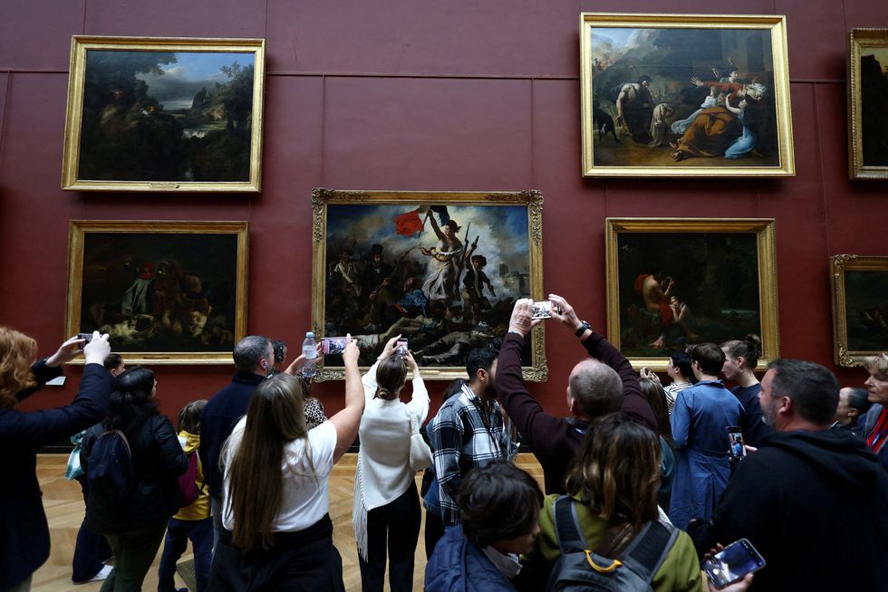 Visitors take pictures of the painting "La Liberte guidant le peuple" (