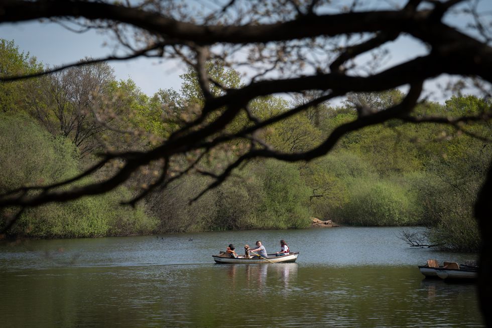 Visitors to Hollow Ponds in Epping Forest enjoy the warm weather.