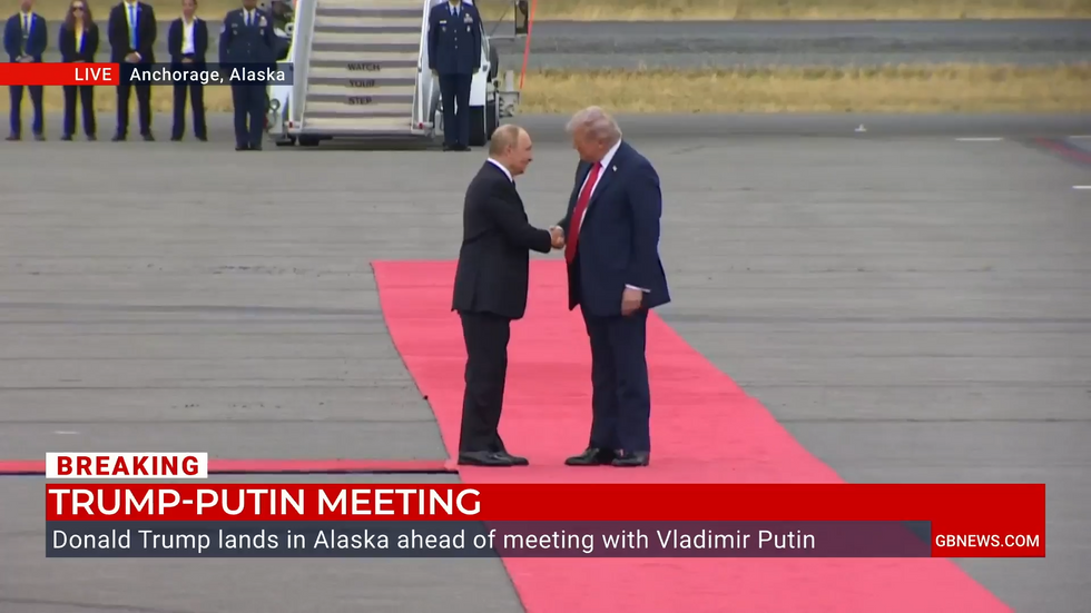 Vladimir Putin and Donald Trump shake hands on the Anchorage tarmac