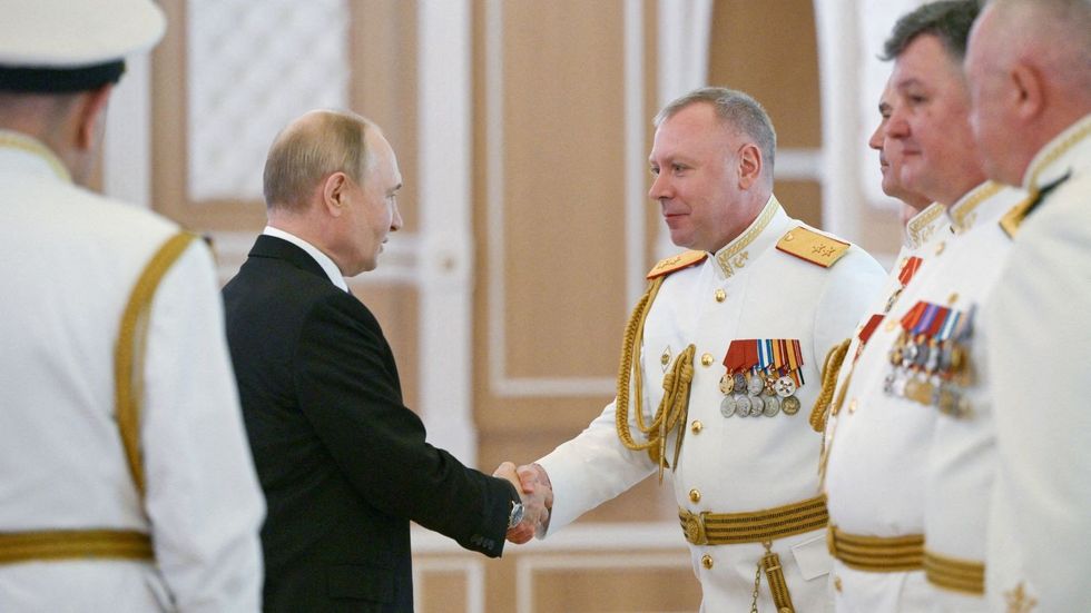 Vladimir Putin greeting naval officers