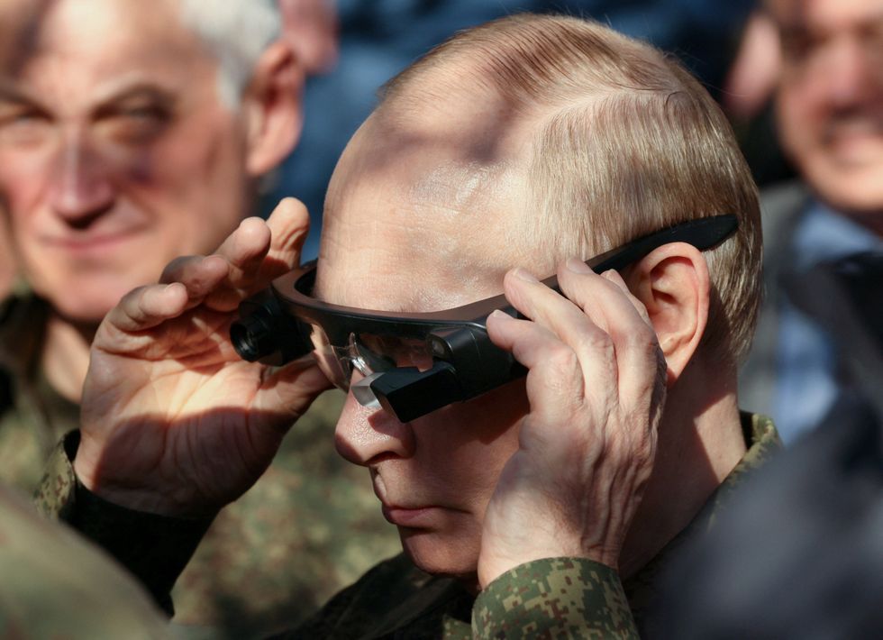 Vladimir Putin inspecting military equipment