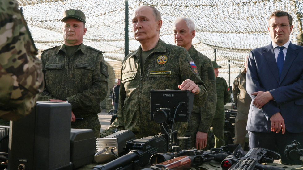 Vladimir Putin inspecting military equipment