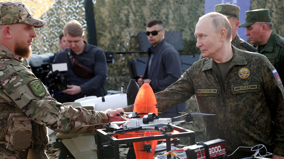 Vladimir Putin inspecting military equipment