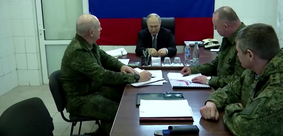 Vladimir Putin sat with Russian military chiefs