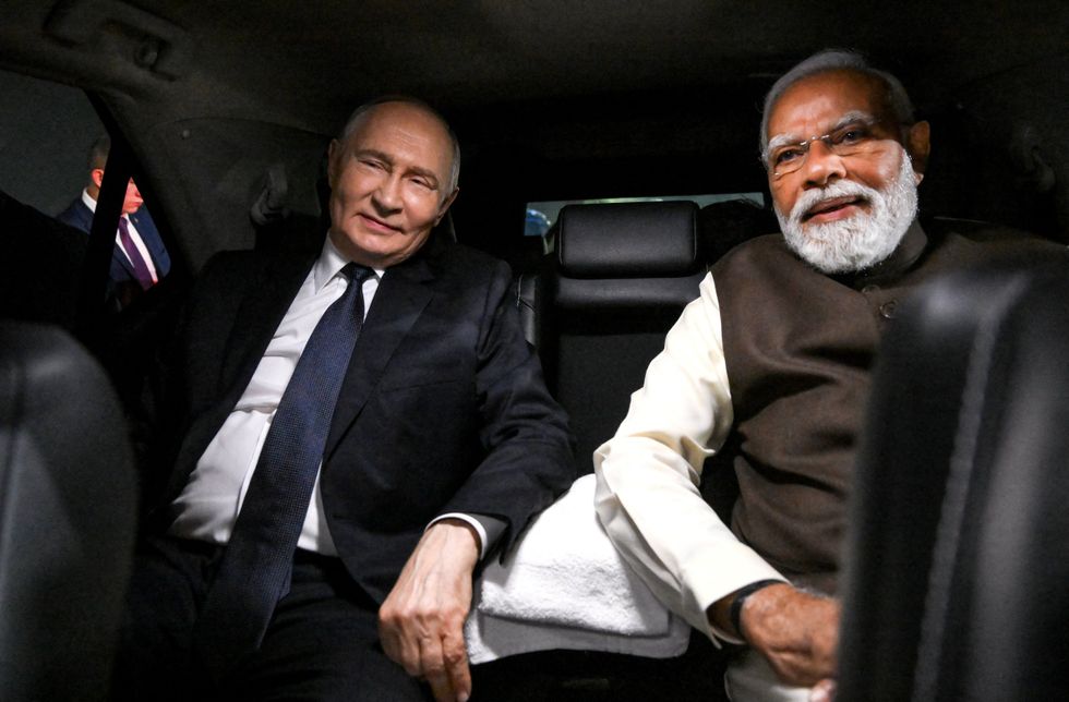 Vladimir Putin shares a car with India's Narendra Modi