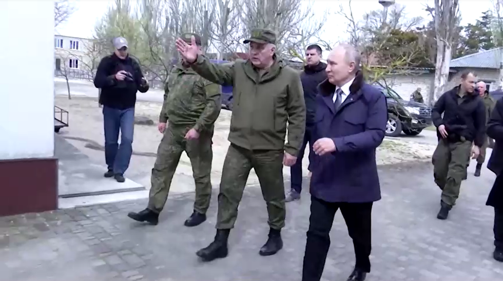Vladimir Putin walking with Russian military chiefs in southern Ukraine
