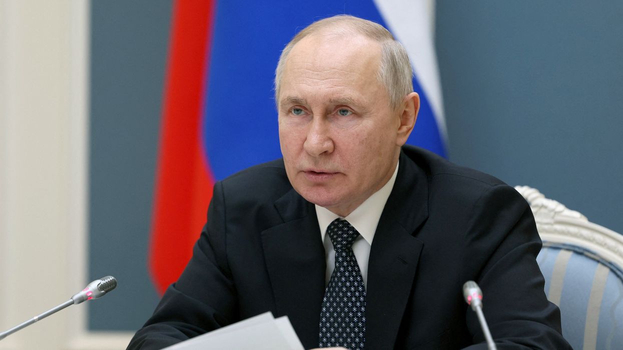 Vladimir Putin with pieces of paper