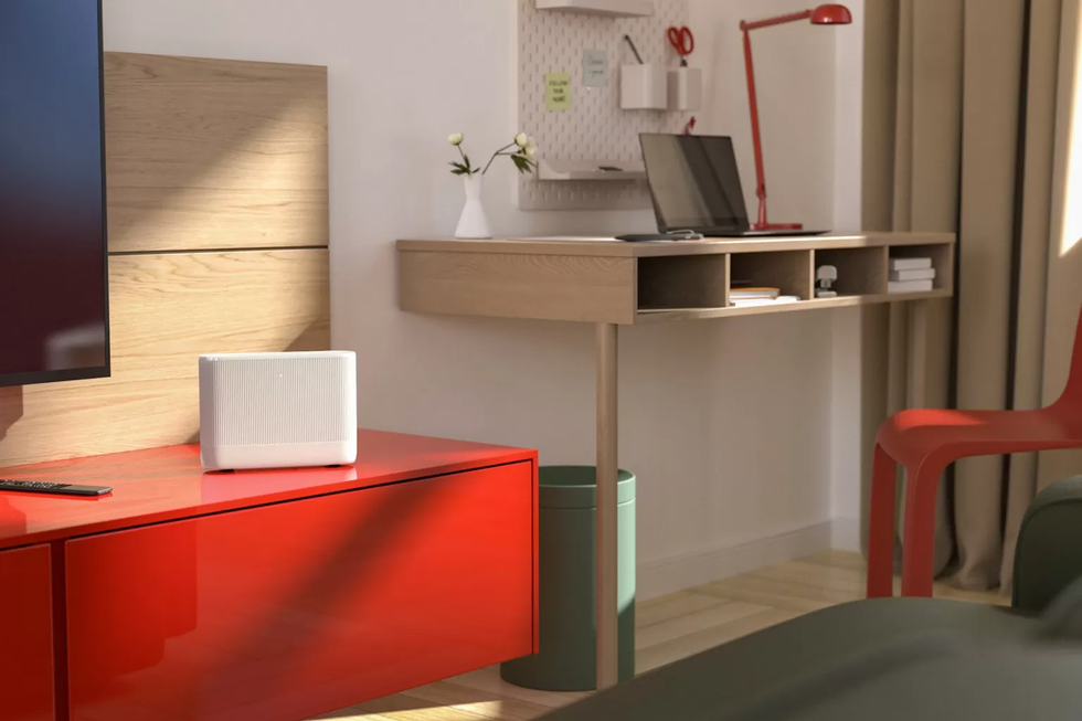 vodafone power hub wifi router pictured on a red sideboard in a bedroom
