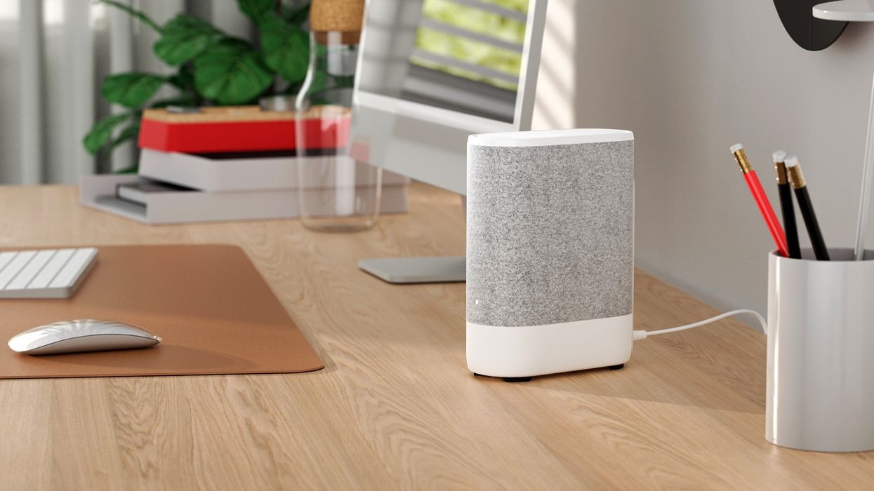 vodafone pro wi-fi router pictured on a desk next to an imac m1