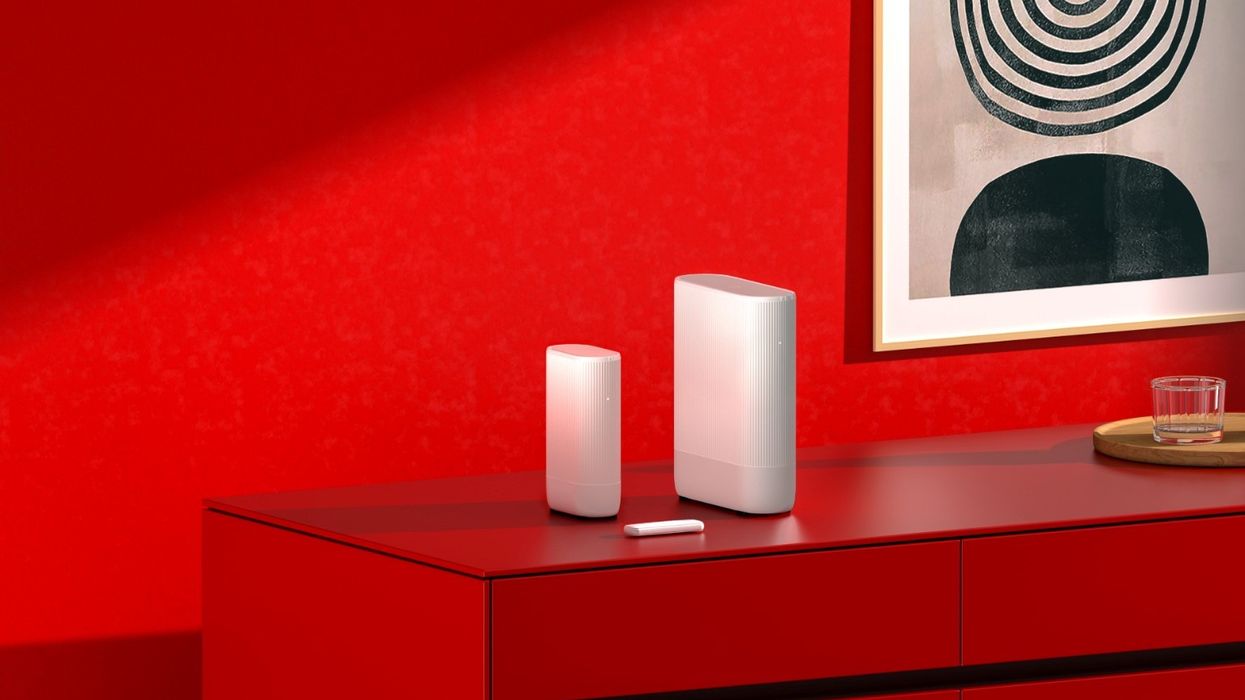 vodafone router with the 4G dongle pictured in a red room
