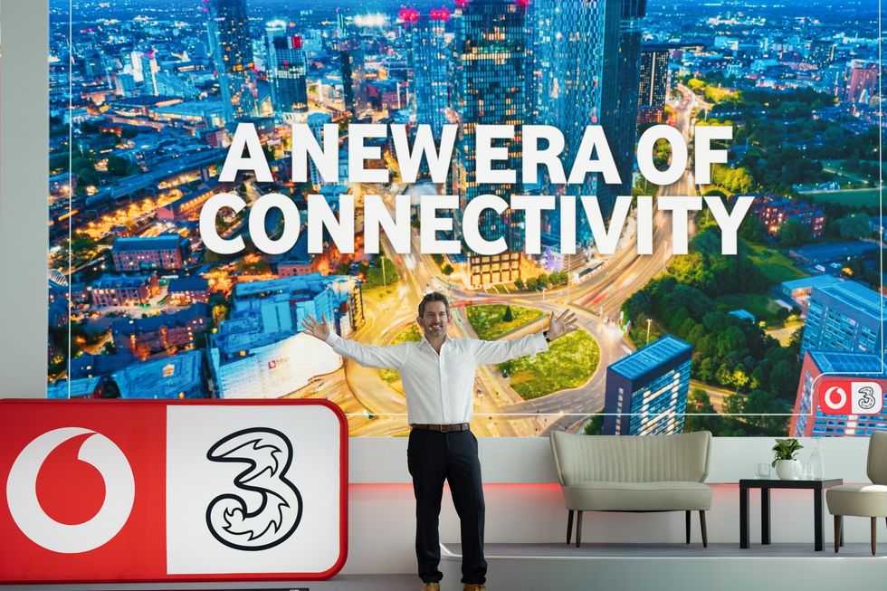 VodafoneThree CEO \u200bMax Taylor on-stage at the company headquarters
