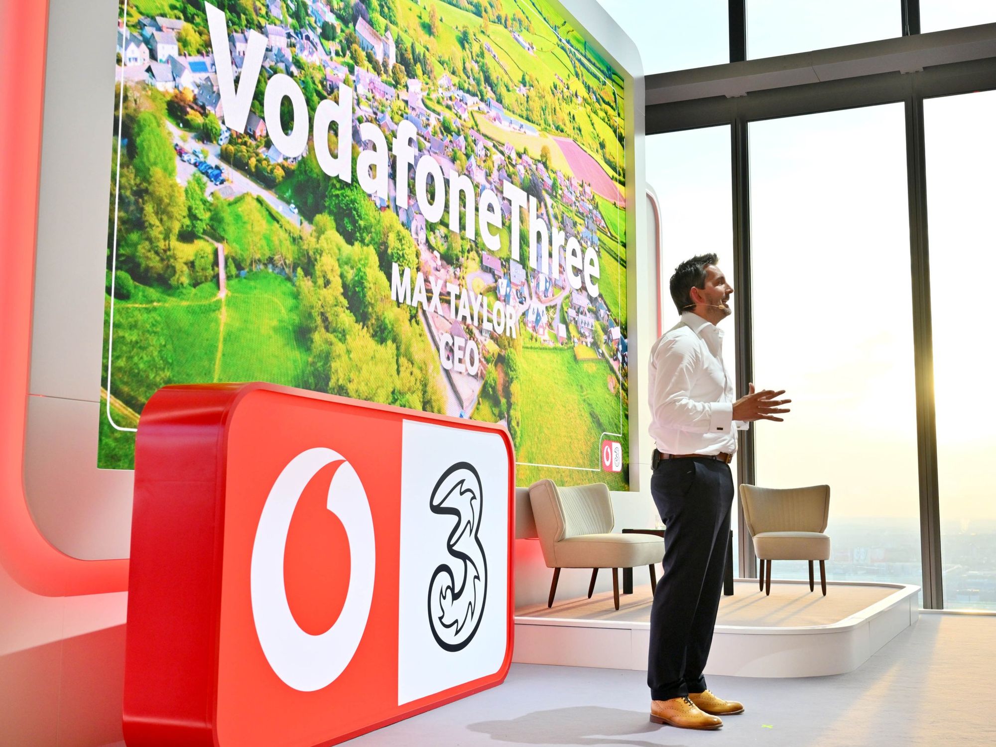 VodafoneThree CEO \u200bMax Taylor on-stage at the company headquarters