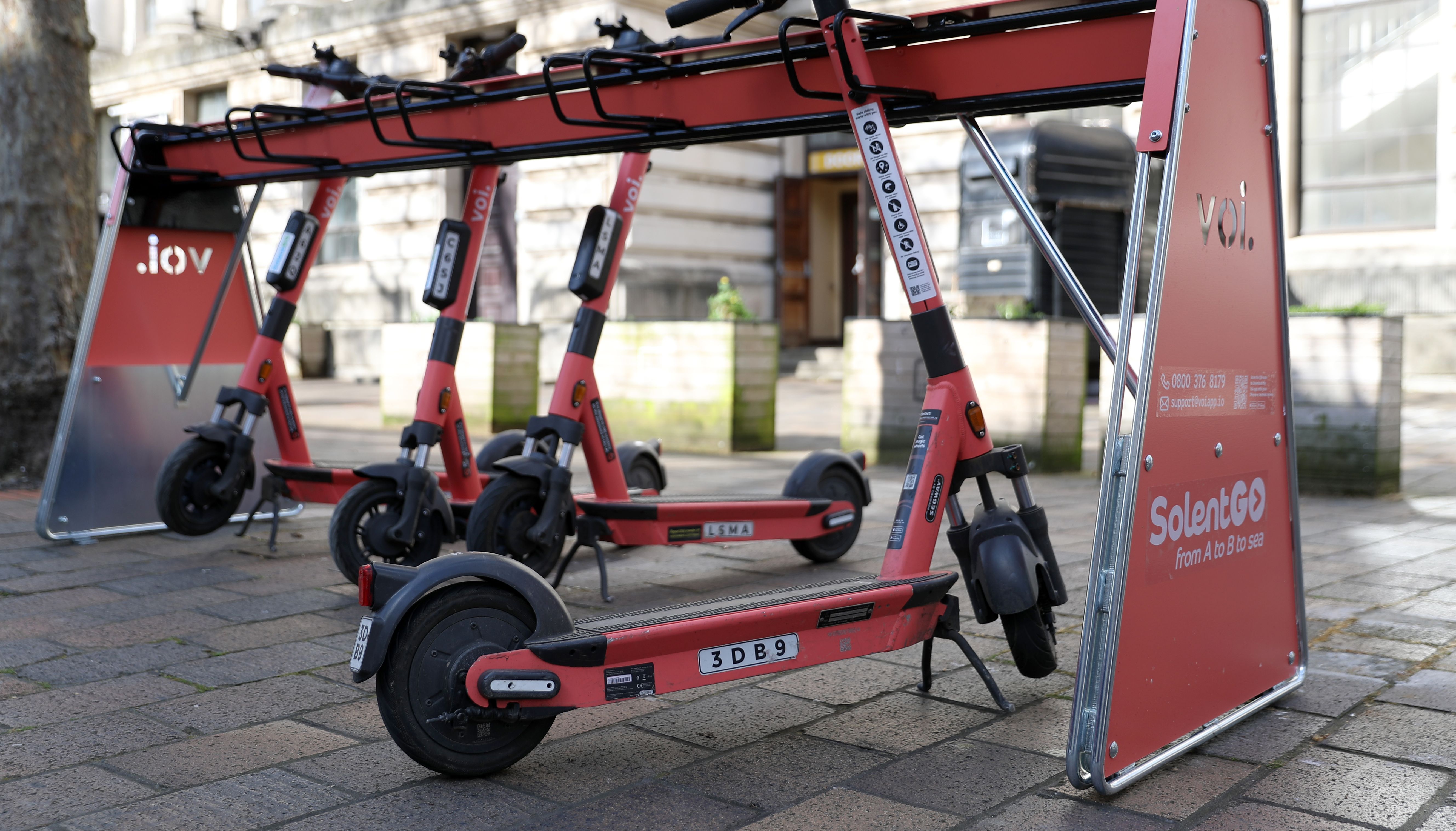 Voi rental e-scooters lined up near to the Guildhall in Portsmouth.