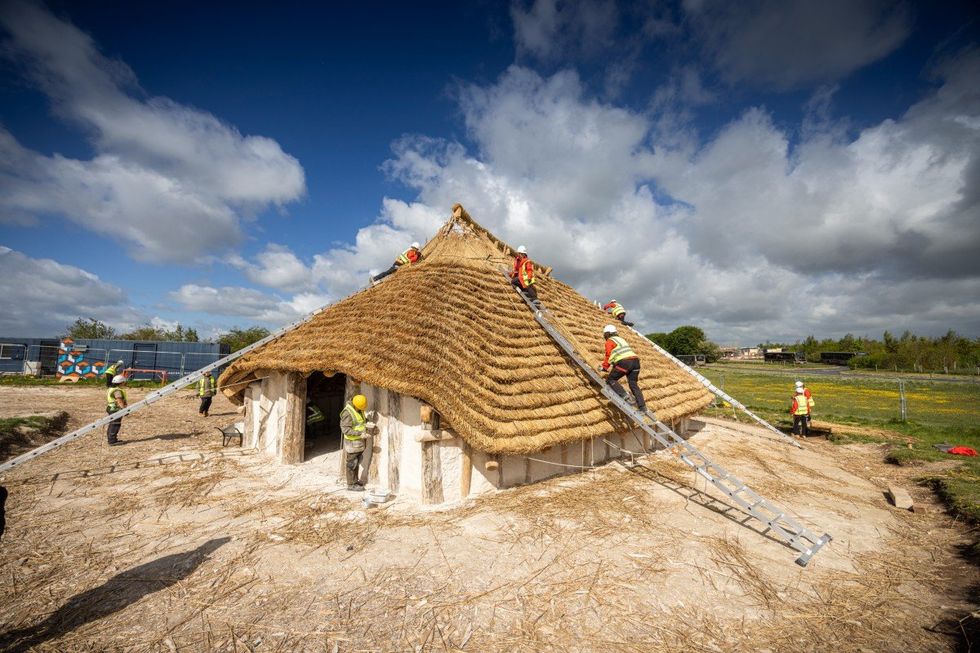 volunteers assisting in the construction of the Kusuma Neolithic Hall near Stonehenge in Wiltshire