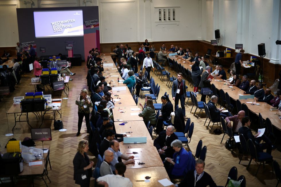 Volunteers wait to begin counting ballot papers for the Westminster City Council local election, at Lindley Hall in Westminster, London, Britain, May 5, 2022. REUTERS/Henry Nicholls