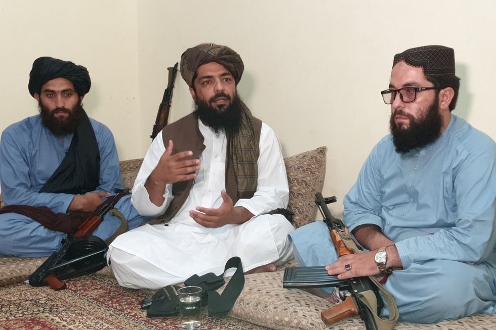Waheedullah Hashimi (C), a senior Taliban commander, gestures as he speaks with Reuters during an interview at an undisclosed location near Afghanistan-Pakistan border August 17, 2021. Picture taken August 17, 2021. REUTERS/Stringer NO RESALES. NO ARCHIVE