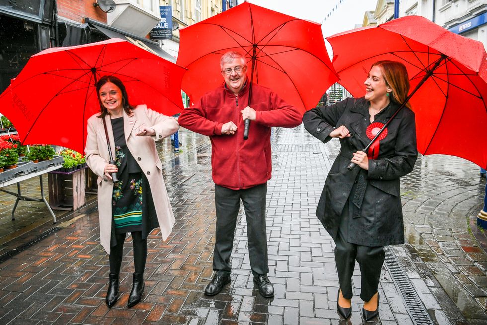 Wales First Minister Mark Drakeford elbow bumps newly elected MS Labour candidates Elizabeth Buffy Williams, Rhondda, left, and Sarah Murphy, Bridgend & Porthcawl, right, as they meet in Porthcawl, Wales. Picture date: Saturday May 8, 2021.