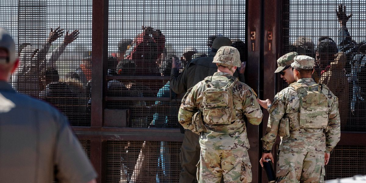 NextImg:Surge of migrants SMASHES through border checkpoint and pushes past armed troops as they try to enter US