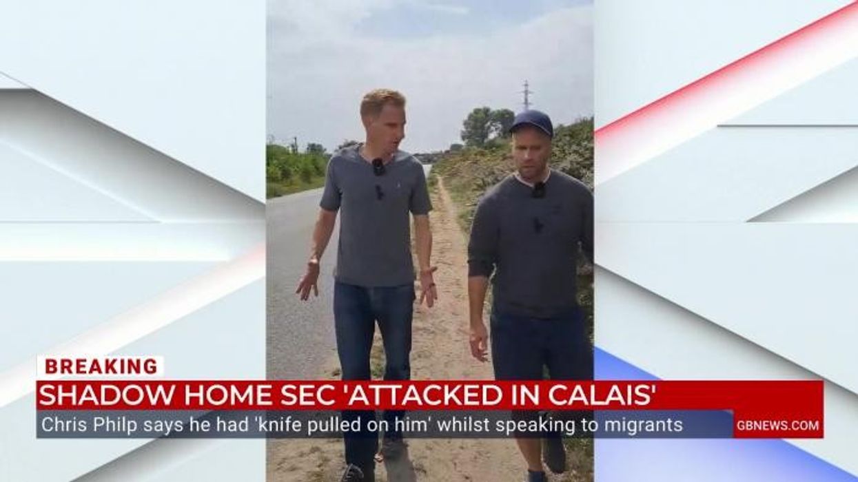 WATCH: Moment that Chris Philp is 'pelted' with glass bottles at migrant camp