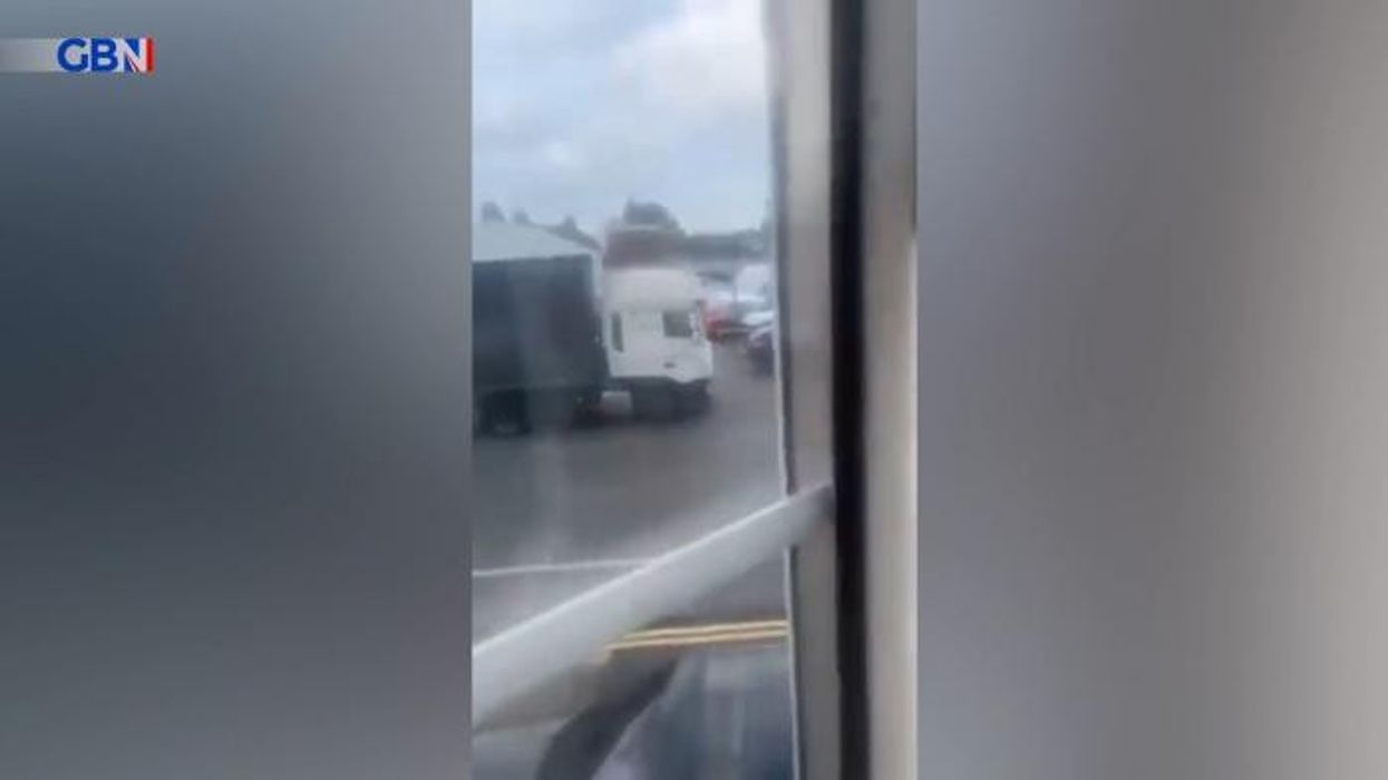 Horrific moment road rage thug climbs into lorry window to attack driver
