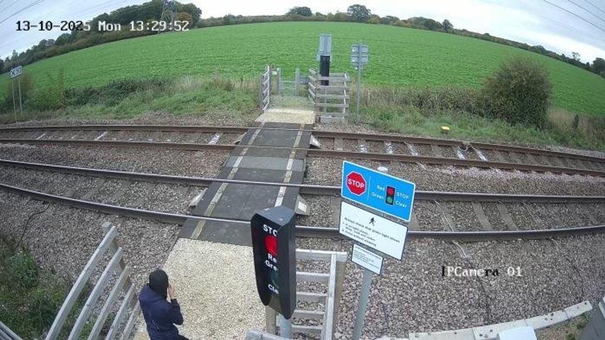 Watch gobsmacking moment teen CHEATS DEATH as he plays 'deadly game' next to 100mph train tracks